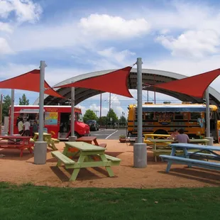 a food truck and picnic tables