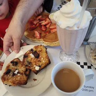 Minnie mouse pancake with strawberries, homemade blueberry muffins and a strawberry milkshake