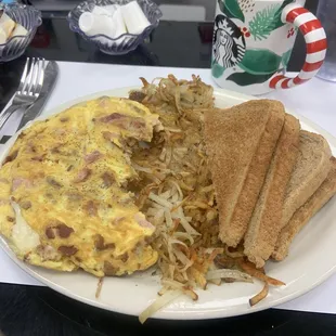 Meat Lovers Omelette with hash browns and wheat toast.