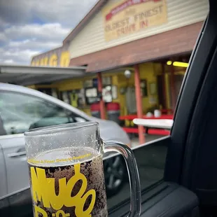 a person holding a mug of beer