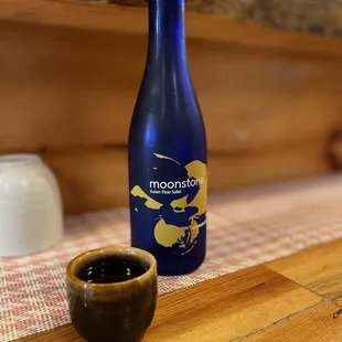 a blue bottle and a wooden bowl