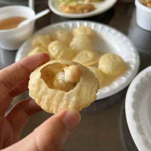 a person holding a piece of food