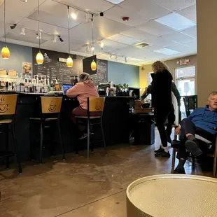 people sitting at tables in a coffee shop