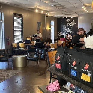 people sitting at tables in a coffee shop