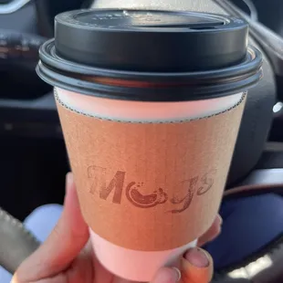 a hand holding a cup of coffee