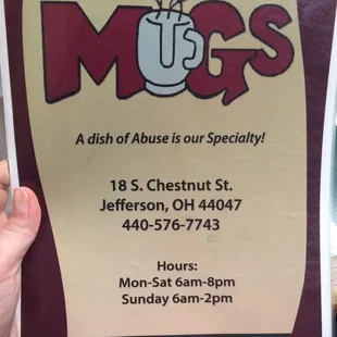 a hand holding a menu