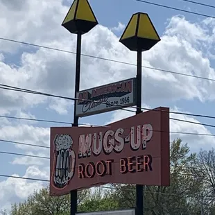 a sign for mugs up root beer