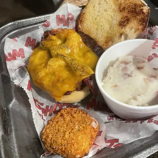 Burger for the kid and a random cheese wedge. Potatoes were missing all of the "loaded" items that were supposed to be on them.