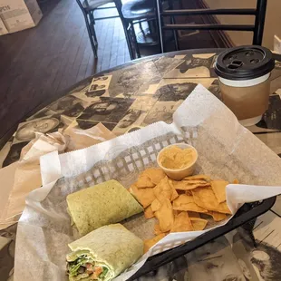 Smoked salmon wrap with pita chips and hummus and a chai latte.