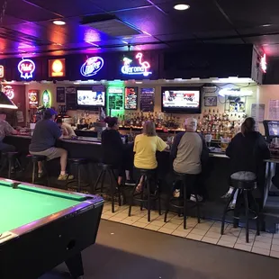 a pool table and neon signs