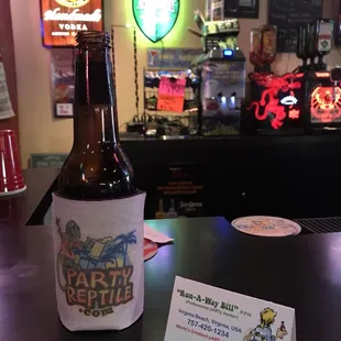 a bottle of beer on a bar counter