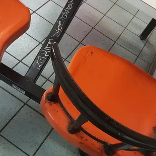 an orange chair and a white table