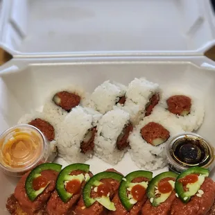 a tray of sushi and vegetables