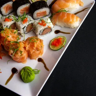 a plate of sushi and rolls