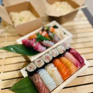 a variety of sushi on a bamboo tray