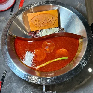 ChengDu Spicy(Beef Oil)+tomato pot, rich tomato thick soup, mixed with a variety of ingredients. The soup reveals an attractive aroma.