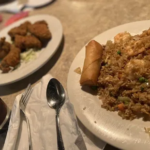 a plate of fried rice with meat and vegetables