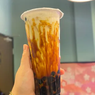 a hand holding a cup