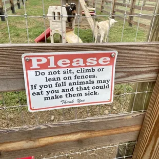 a fence with a sign stating that there is no animal in the area