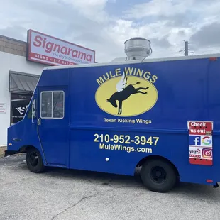 a blue truck parked in front of a building
