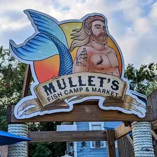 a sign for mullet&apos;s fish camp and market