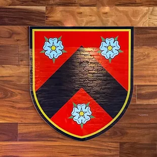 a coat of arms on a wooden wall