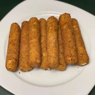 a white plate with five mulligani sticks on it