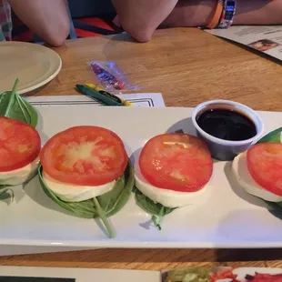 Caprese salad.. got 4 pcs. but menu showed 8.  Looked nothing like the stock photo they printed.