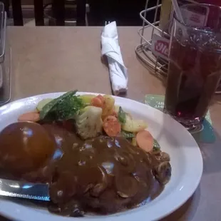 Salisbury steak with mashed potatoes and gravy and mixed veggies and drink $10 dinner special