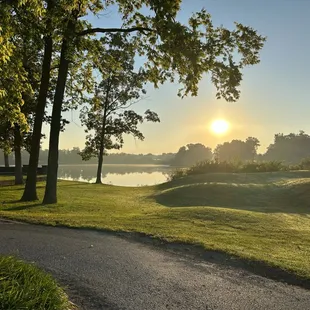 the sun setting over a golf course