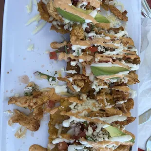 mmm plantains topped with chick, tomatoes , avocado and a yummy aoli