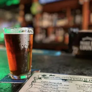 a glass of beer and menu
