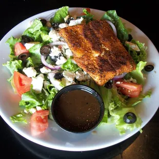 Greek Salad Special with Blackened Salmon Romaine lettuce, Feta cheese, tomato, onion, black olives, blackened salmon.  balsamic vinaigret