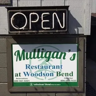 a sign for mulligan's restaurant at woodson bend