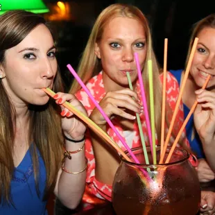 three women drinking a drink