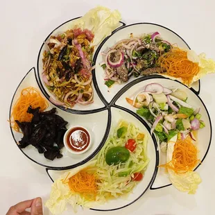 Five separate dishes displaying a flower when assembled