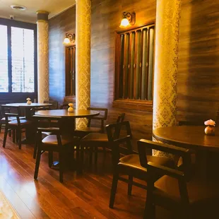 a restaurant with wooden tables and chairs