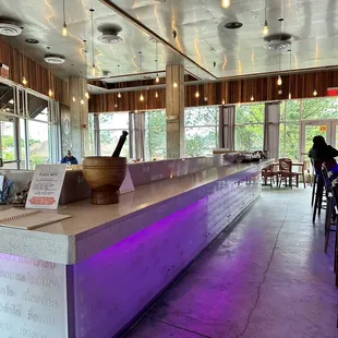 a bar with purple lighting