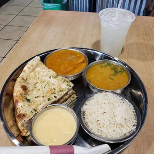 Butter chicken, garlic naan bread, lentil soup, rice,  rice pudding, and a  Lime soda!!
