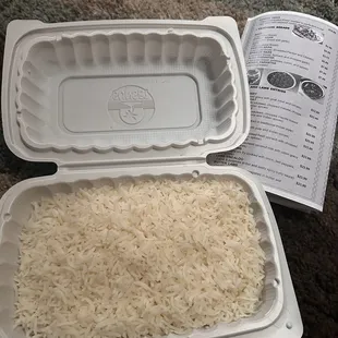 rice in a styrofoam container and a recipe book