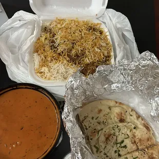 Goat biryani, butter chicken, and garlic naan