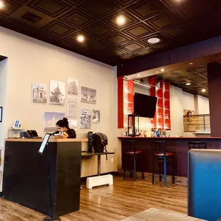 a woman sitting at a counter in a restaurant