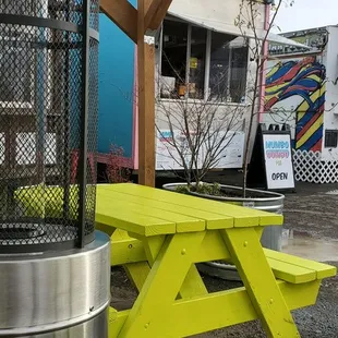 a picnic table and a food truck