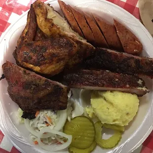 Three meat plate: Ribs. Chicken. And sausage with Cole slaw and potato salad.