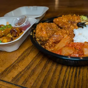 a bowl of rice with meat and vegetables