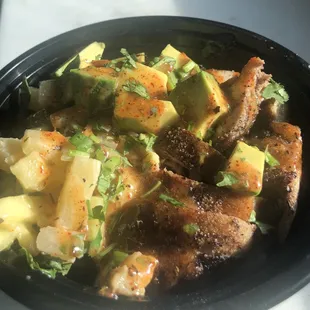 The Cha Cha Bowl, jerk chicken, white rice, Caribbean black beans, zucchini and pineapple salad, avocado, coconut jerk sauce and cilantro.