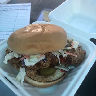 The Dirty bird, fried chicken with Mumpy's Dirty Sauce, southern slaw, pickles on a toasted bun.