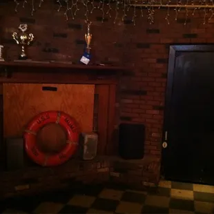 a brick wall with a door and a life preserver