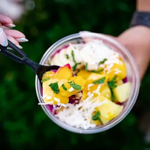 a person holding a bowl of food