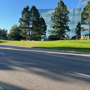 an empty street with a building in the background